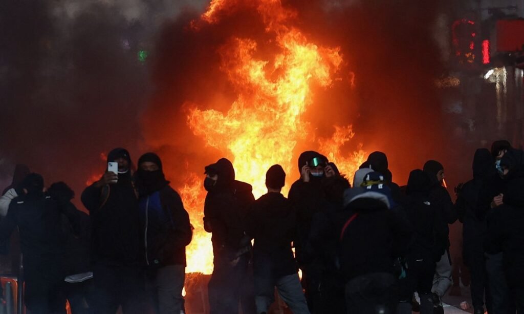 Flames and smoke rise during civil unrest, the day after a national day of demonstrations against the cost of living and rising fuel prices, in Paris, France, October 18, 2026. REUTERS/Abdul Saboor